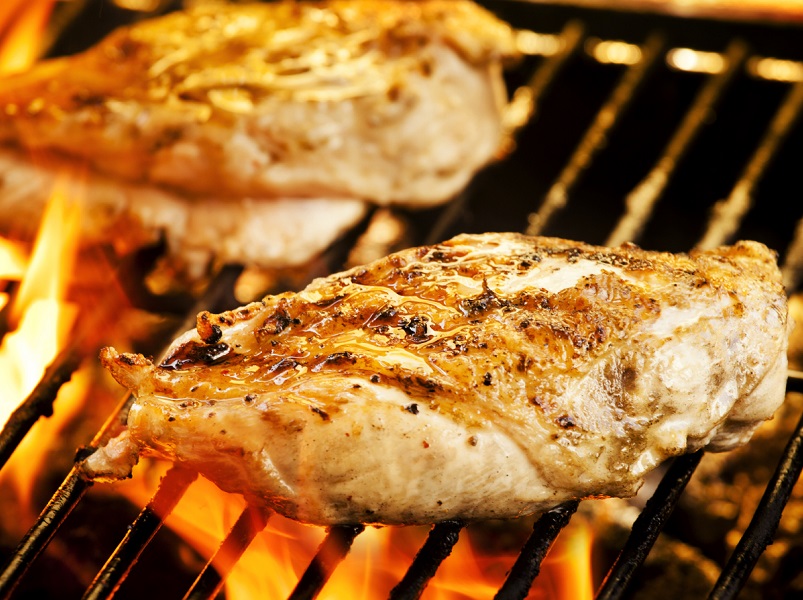 Photograph of two chicken filets on the barbecue