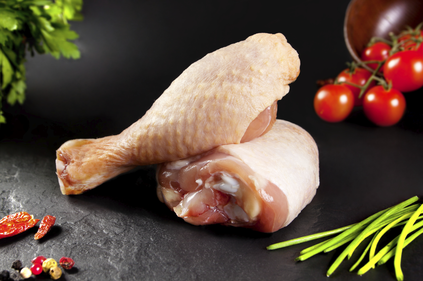 Fresh and raw meat. Raw chicken thighs white  ready to cook. Background black blackboard